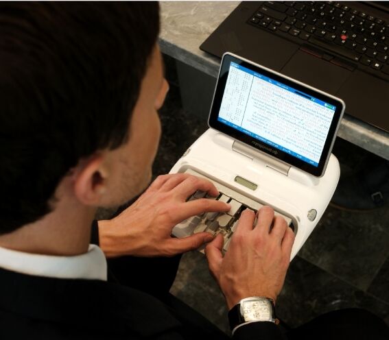 Court reporter types on stenograph