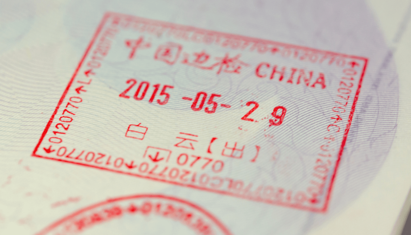 A close-up of a red Chinese passport stamp dated 2015-05-29, featuring Chinese characters and the word "CHINA.
