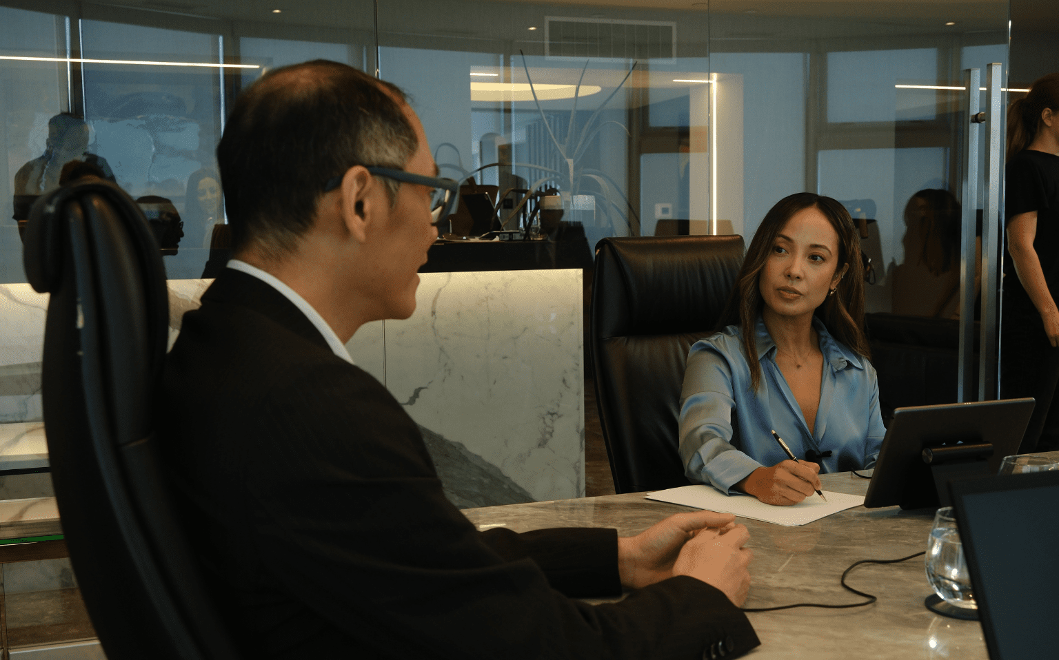 Interpreter and witness at a table during an international deposition