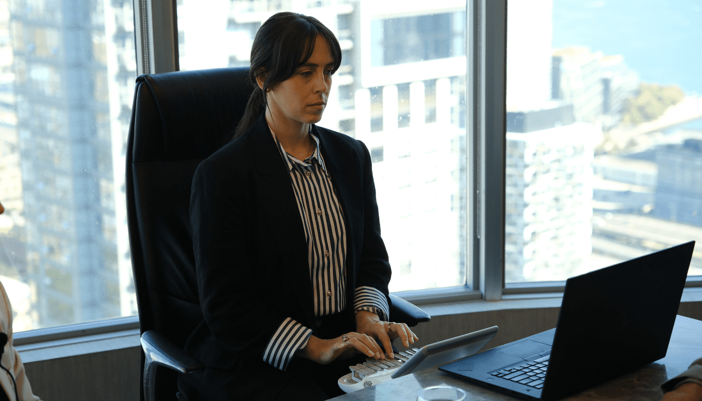 Stenographic court reporter typing on stenotype machine