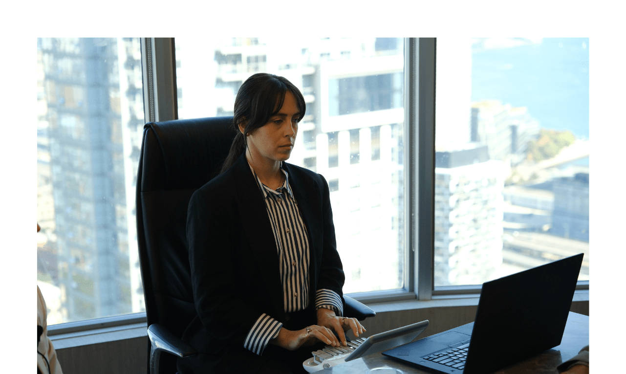 Stenographic court reporter typing on stenotype machine during a deposition