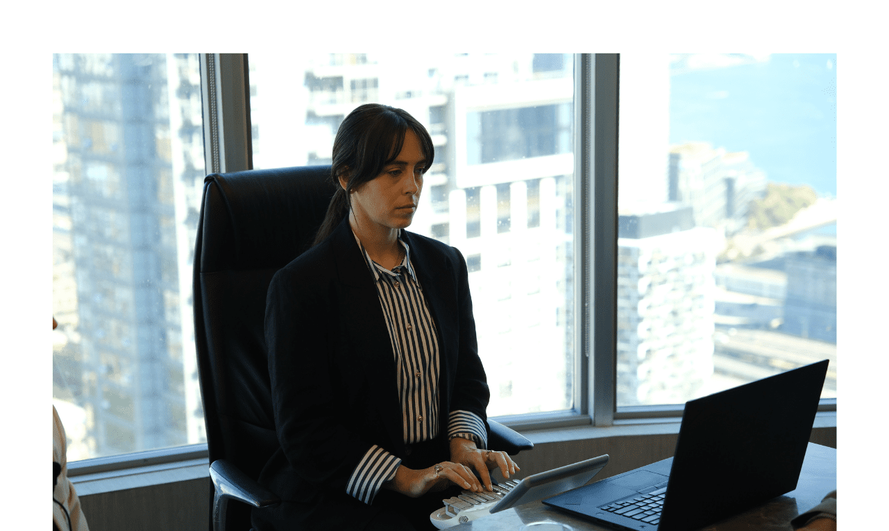 Stenographic court reporter typing on stenotype machine during a deposition