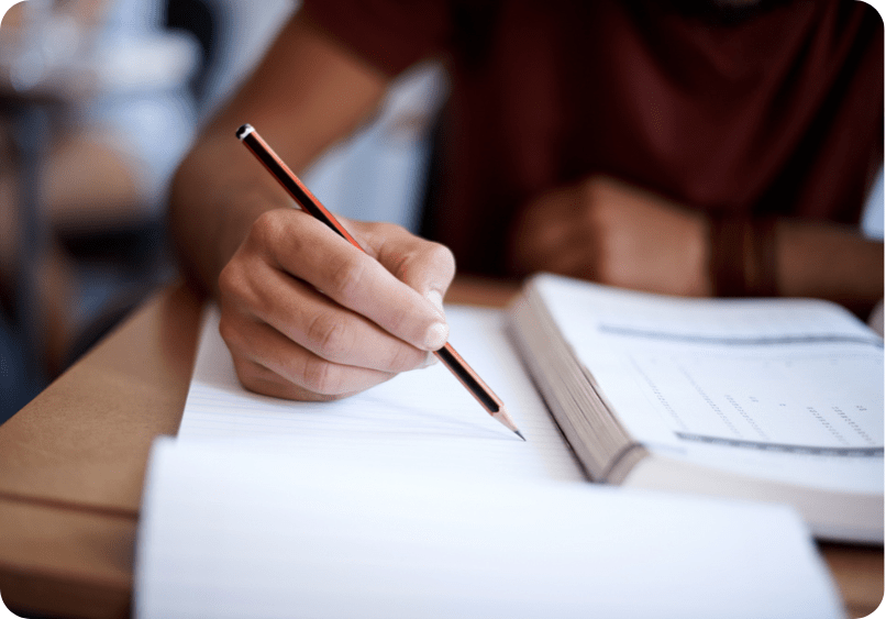 Court reporting student with pencil and papers studying for the registered professional reporter exam