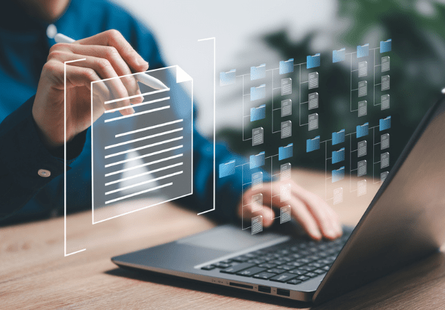 Person with stylus preparing for a deposition, looking at laptop screen, folder, and files